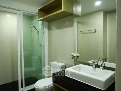 Modern bathroom with glass shower and sleek fixtures