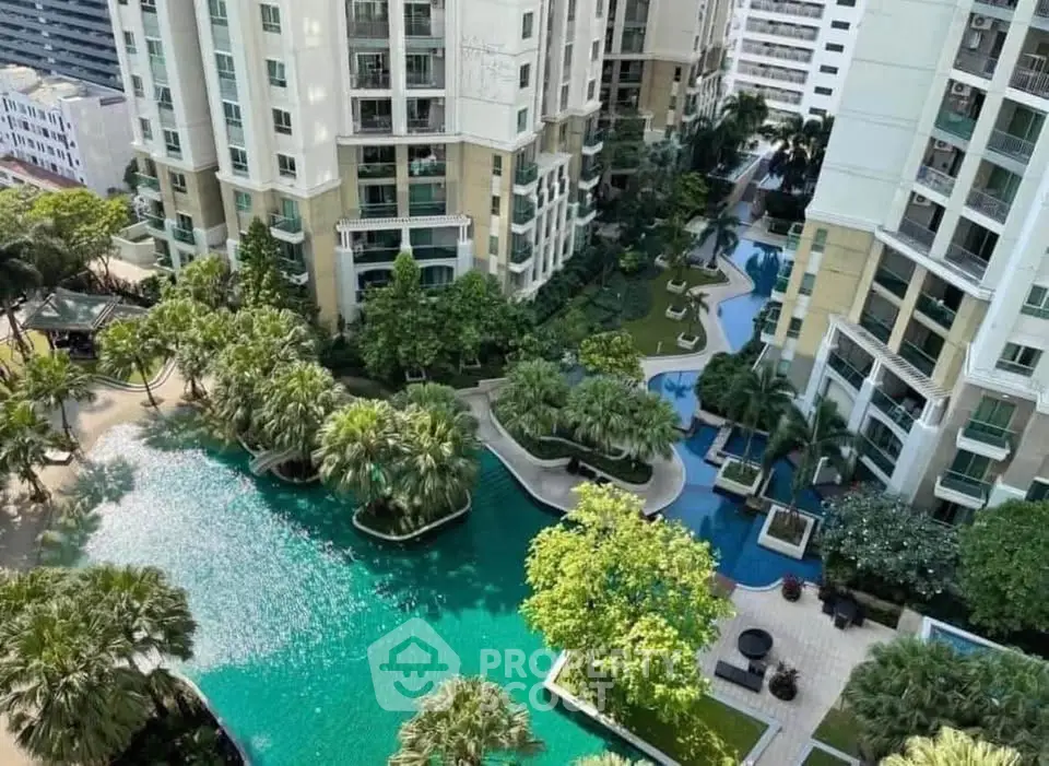 Luxurious residential complex with stunning pool and lush gardens, offering a serene urban oasis.