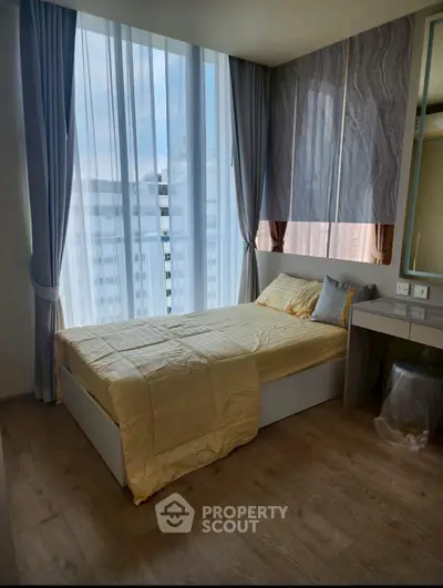 Modern bedroom with floor-to-ceiling windows and elegant decor