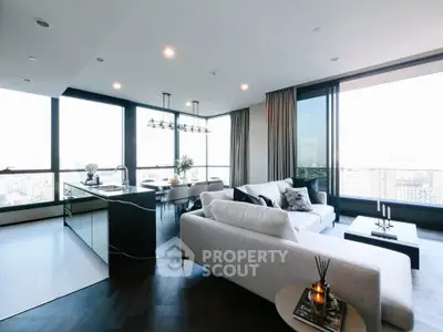 Luxurious modern living room with panoramic city views and elegant open kitchen layout.