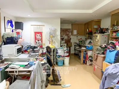 Cluttered interior space with various household items and appliances, showcasing potential for organization and improvement.
