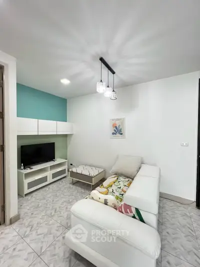 Modern living room with stylish decor and comfortable seating in a cozy apartment.