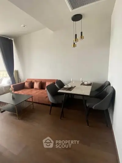 Modern living room with stylish furniture and elegant lighting, perfect for cozy gatherings.