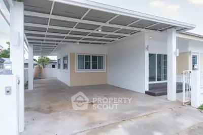 Modern single-story home with spacious carport and sleek exterior design.