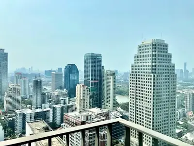 Stunning cityscape view from high-rise balcony in urban setting, showcasing modern architecture.