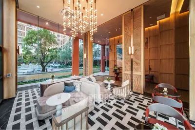 Modern living room with stylish decor and large windows offering a scenic view.