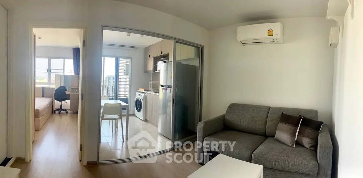 Modern apartment with open layout, featuring a cozy living room, kitchen, and bedroom.