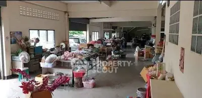 Spacious indoor area with tables and various items, ideal for storage or commercial use.