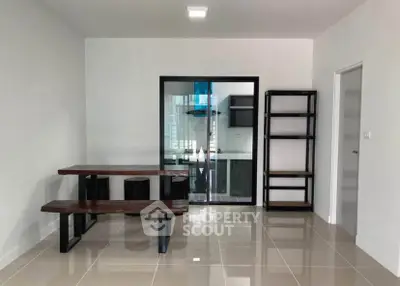 Modern dining area with sleek wooden table and open kitchen view