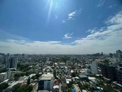 Stunning cityscape view from high-rise building under clear blue sky.
