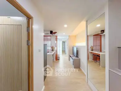 Modern open-plan living area with sleek design and wooden flooring