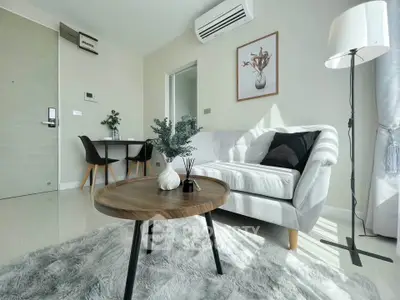 Modern living room with cozy sofa, stylish decor, and natural light