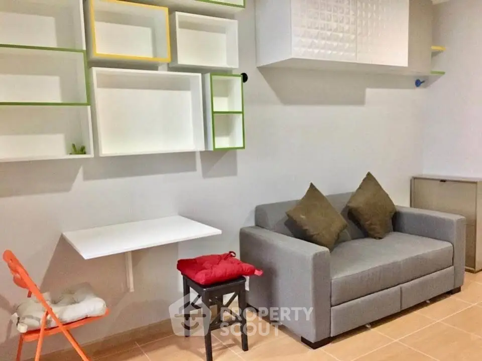 Modern living room with stylish shelving and cozy gray sofa