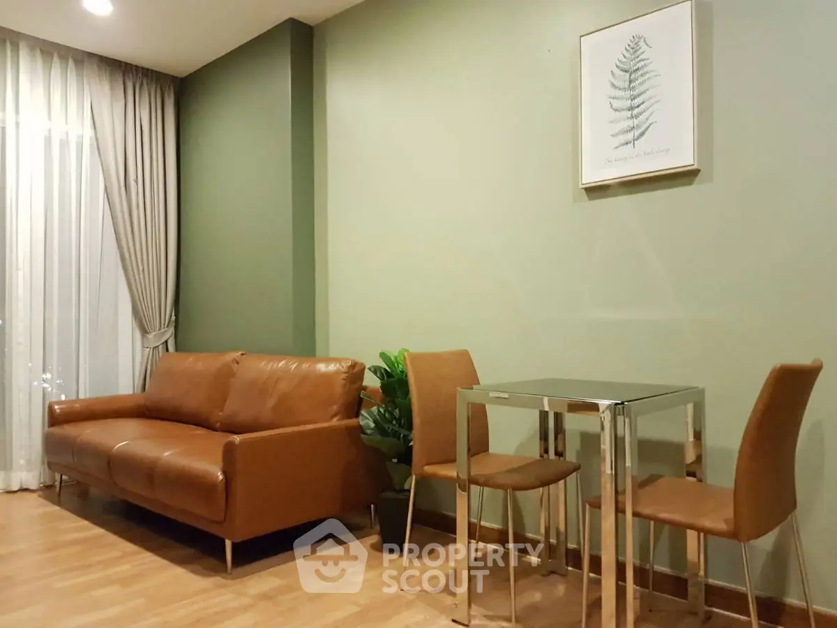 Modern living room with brown leather sofa and glass dining table