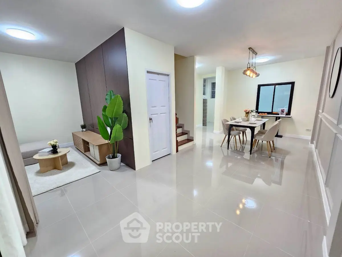 Spacious modern living and dining area with elegant decor and natural light.