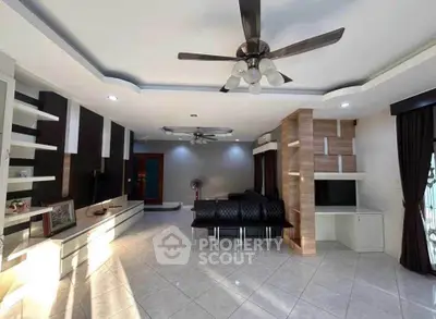 Spacious modern living room with ceiling fan and stylish decor