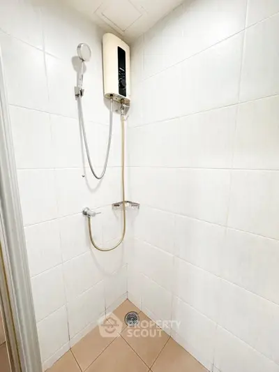 Minimalist bathroom with tiled walls and modern shower setup