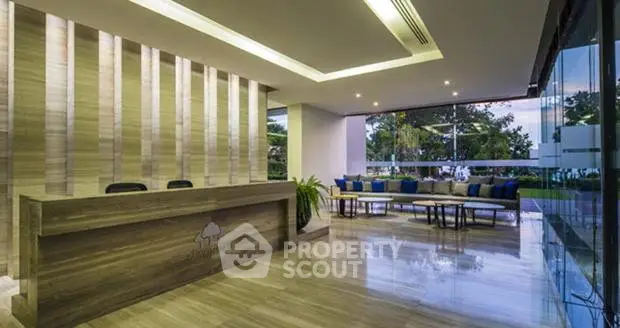 Luxurious modern lobby with sleek design and garden view, perfect for upscale living.