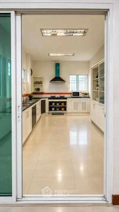 Spacious modern kitchen with sleek cabinetry and stainless steel appliances, perfect for culinary enthusiasts.