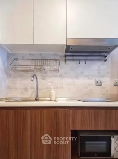 Modern kitchen with sleek cabinets and built-in appliances, perfect for urban living.