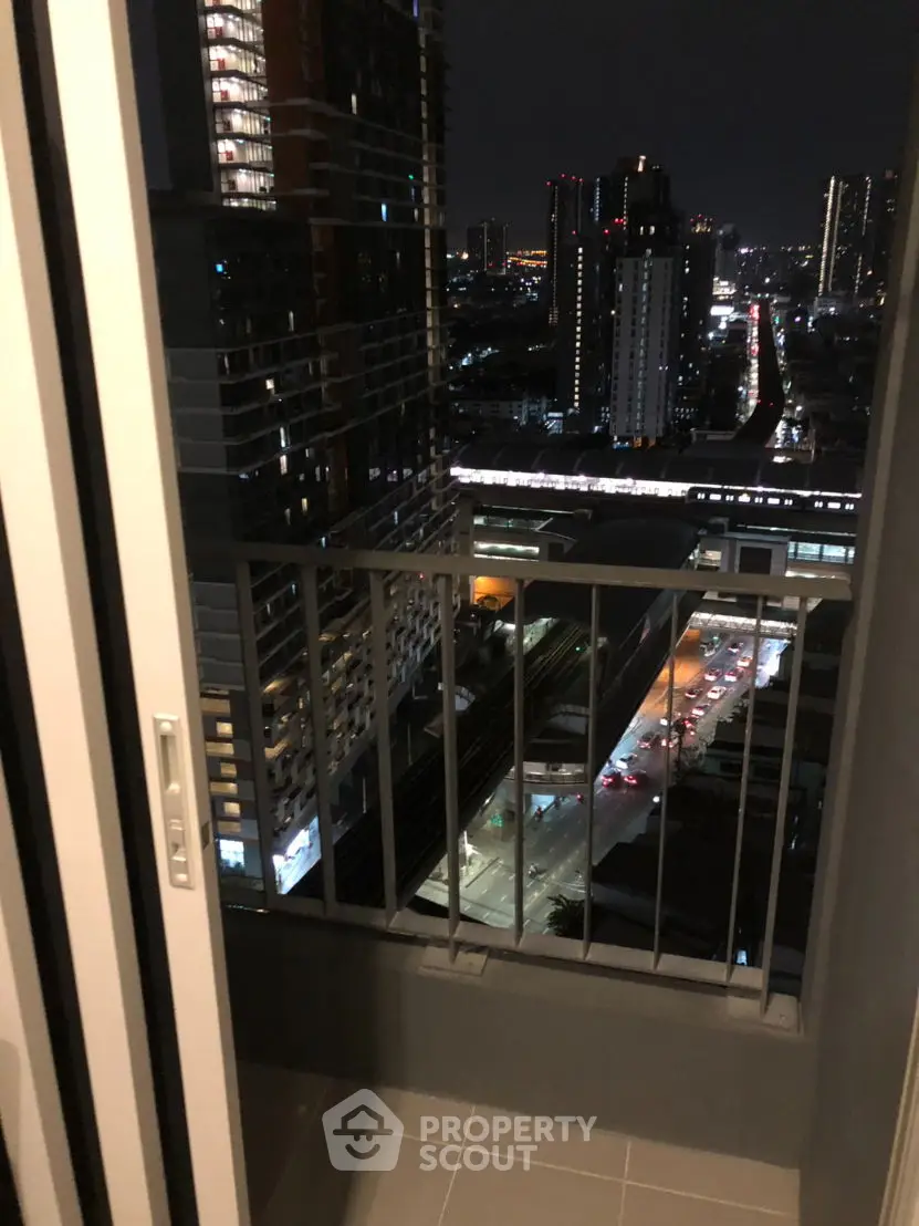 Stunning city view from a modern high-rise balcony at night, perfect for urban living.