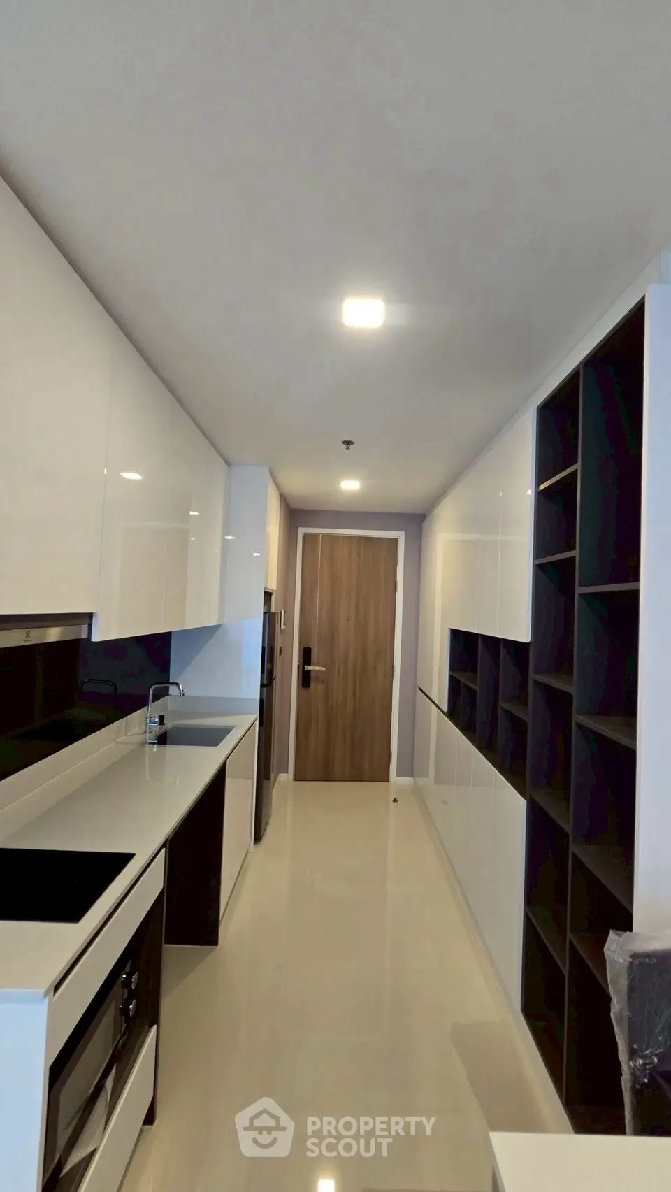 Modern kitchen with sleek cabinetry and built-in appliances in a stylish apartment.