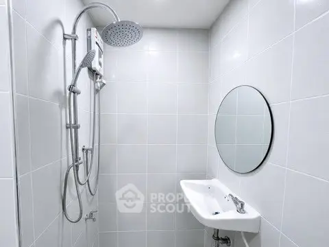 Modern minimalist bathroom with sleek shower and round mirror