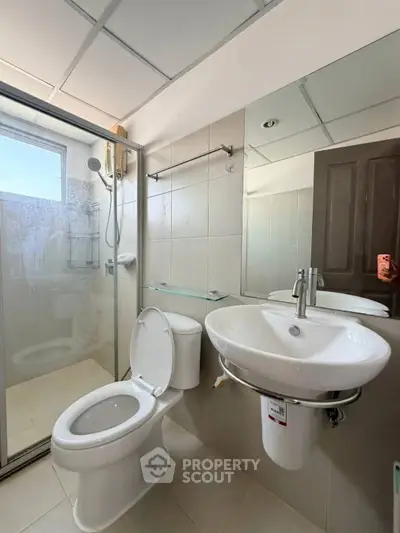 Modern bathroom with glass shower and sleek fixtures