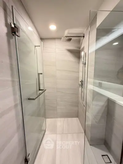 Modern bathroom with glass shower enclosure and sleek tile design
