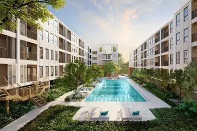 Luxurious modern apartment complex with central swimming pool and lush greenery