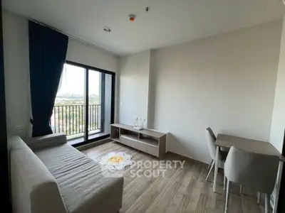 Modern living room with balcony view, stylish furniture, and wooden flooring in a bright apartment.