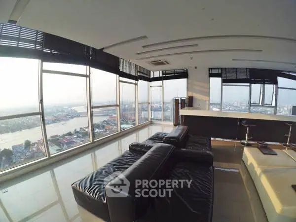 Luxurious living room with panoramic city and river views, featuring sleek leather furniture and modern design.