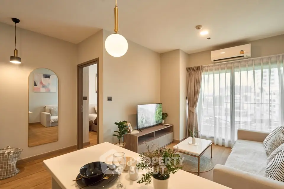 Modern living room with stylish decor and natural light in a cozy apartment.