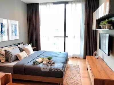 Modern bedroom with large window, stylish decor, and cozy ambiance.