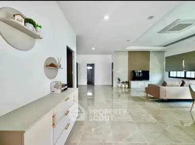 Spacious modern living room with sleek design and elegant furnishings.