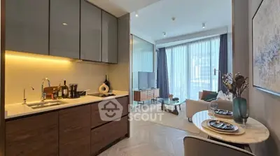 Modern open-plan kitchen and living room with stylish decor and natural light.