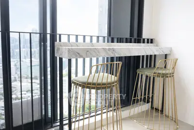 Chic balcony with modern bar stools and stunning city view, perfect for urban living.