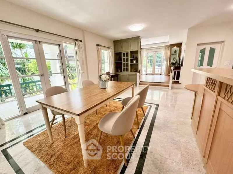 Spacious dining area with elegant decor and large windows for natural light