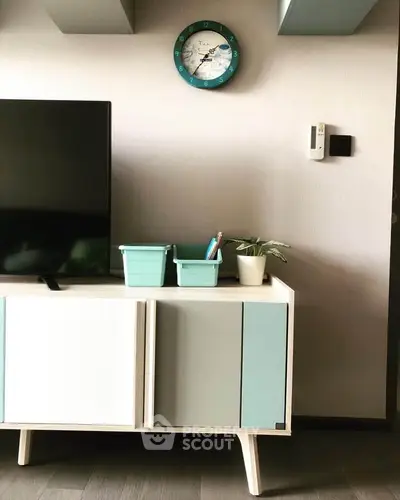 Modern living room with stylish TV stand and wall clock