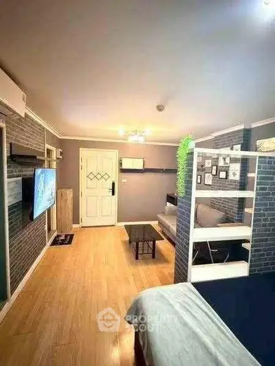 Modern living room with stylish decor and open layout, featuring a cozy seating area and wall-mounted TV.