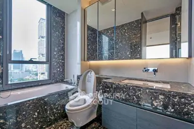 Luxurious bathroom with city view and elegant marble finishes.