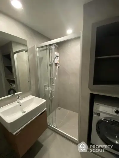 Modern bathroom with shower and washing machine in sleek design