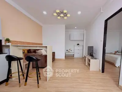 Modern open-plan living room with stylish decor and cozy seating area.