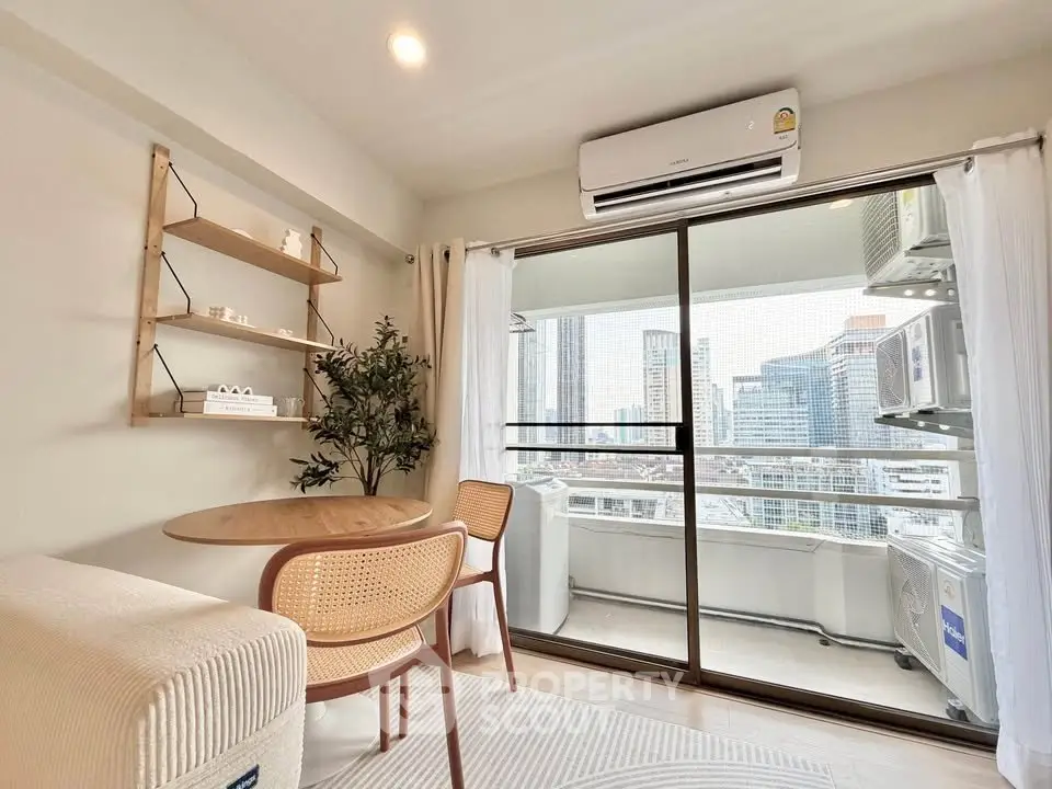 Modern living room with balcony view in urban apartment, featuring stylish furniture and air conditioning.