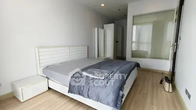 Spacious modern bedroom with sleek design and ample natural light.