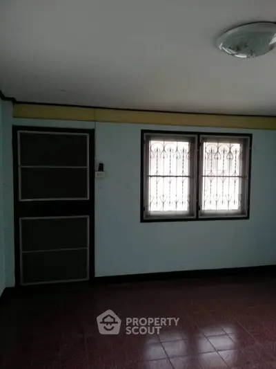 Cozy room with barred windows and tiled floor, perfect for customization.