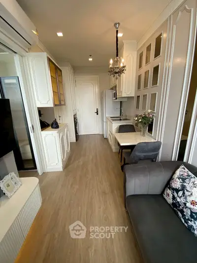 Chic modern living room with elegant decor and compact dining area, featuring stylish lighting and cozy seating.