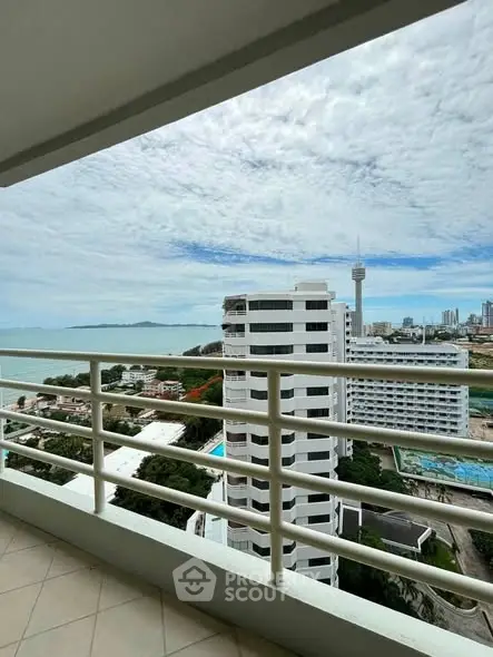 Stunning ocean view from high-rise balcony overlooking cityscape and coastline.