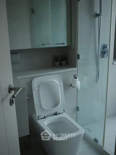 Modern bathroom with sleek fixtures and glass shower enclosure