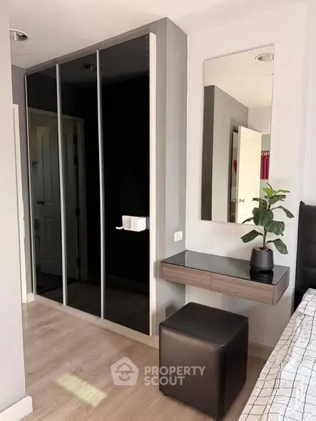 Modern bedroom with mirrored wardrobe and stylish vanity area